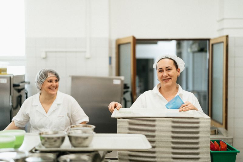 Dions kitchen staff preparing fresh pizza ingredients